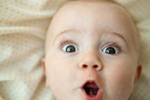 Baby looking at camera with surprised expression, portrait